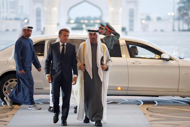 UAE President Sheikh Mohamed bin Zayed Al-Nahyan (R) receives France's President Emmanuel Macron (L) at Qasr al-Watan presidential palace in Abu Dhabi on October 19, 2026. Macron began a Gulf tour on October 19 aimed at securing oil and diesel supplies in an effort to bring down prices, after a weekend of violent protests sparked by soaring living costs. (Photo by Benoit Tessier / POOL / AFP)