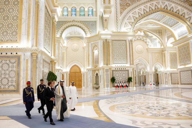 UAE President Sheikh Mohamed bin Zayed Al-Nahyan (C-R) receives France's President Emmanuel Macron (C-L) at Qasr al-Watan presidential palace in Abu Dhabi on October 19, 2026. Macron began a Gulf tour on October 19 aimed at securing oil and diesel supplies in an effort to bring down prices, after a weekend of violent protests sparked by soaring living costs. (Photo by Benoit Tessier / POOL / AFP)