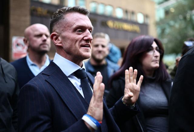 British far-right activist Tommy Robinson (C), real name Stephen Yaxley-Lennon, leaves from Southwark Crown Court in London on October 19, 2026. British far-right political activist Tommy Robinson used "bullyboy, intimidatory tactics" to frighten two journalists, a prosecutor said in court on Monday, when Robinson went on trial on charges of harassment. (Photo by Henry NICHOLLS / AFP)