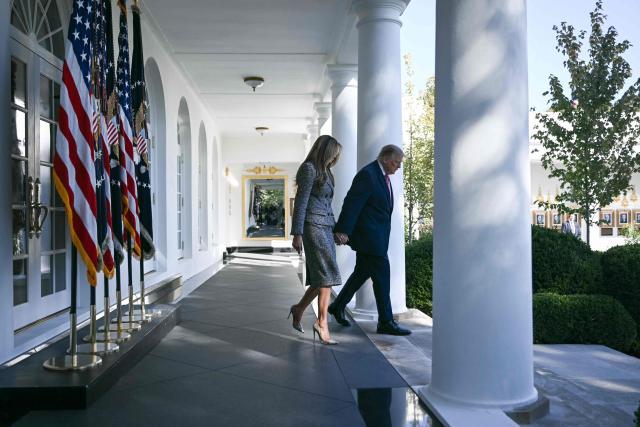 US President Donald Trump and First Lady Melania Trump arrive for an executive order signing ceremony in the Rose Garden of the White House in Washington, DC, on October 19, 2026. The executive order aims to a create a Women’s Health Division at the National Institutes of Health (NIH) and a White House Women’s Health Task Force. (Photo by Brendan SMIALOWSKI / AFP)