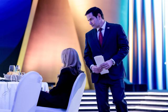 US Secretary of State Marco Rubio returns to his seat next to his wife Jeanette Dousdebes Rubio after delivering a speech during a dinner with Uzbekistan's President Shavkat Mirziyoyev and the American-Uzbek Business and Investment Council (AUBIC) at the Congress Center in Samarkand on October 19, 2026. (Photo by Kylie Cooper / POOL / AFP)