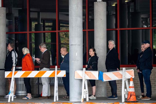 People wait in line at a polling location on the first day of early voting in Texas for the midterm elections, at the West Gray Metropolitan Multiservice Center in Houston, Texas, on October 19, 2026. Democrat James Talarico is facing Republican and Texas Attorney General Ken Paxton in a race for one of Texas's US Senate seats. No Democrat has won statewide office in the conservative southern state since 1994, and Trump carried Texas by nearly 14 percentage points in the 2024 presidential election. (Photo by RONALDO SCHEMIDT / AFP)