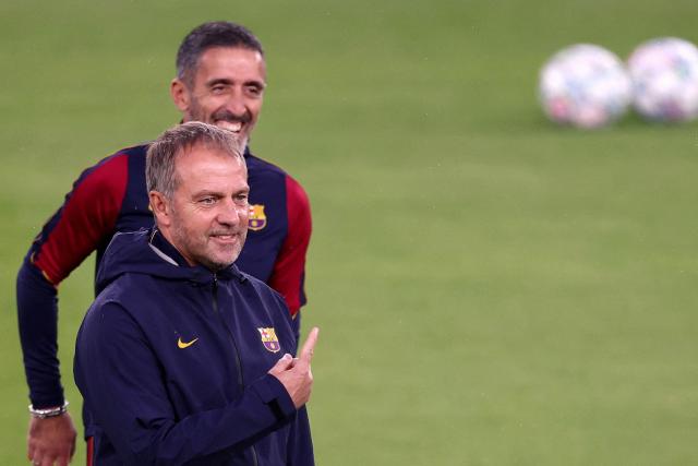 Barcelona's German head coach Hansi Flick (R) gestures during a training session at the Parc des Princes stadium in Paris on October 19, 2026, on the eve of the UEFA Champions League first round day 3 football match between Paris Saint Germain (PSG) and FC Barcelona. (Photo by FRANCK FIFE / AFP)