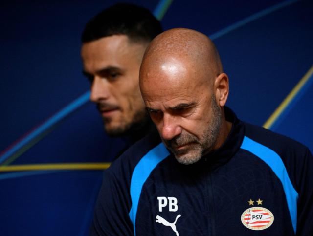 PSV Eindhoven’s coach Peter Bosz and and Serbian player Filip Kostic (back) attend a press conference ahead of their UEFA Champions League first round day 3 football match against FC Porto, at the Dragao Stadium in Porto, on October 19, 2026 (Photo by MIGUEL RIOPA / AFP)