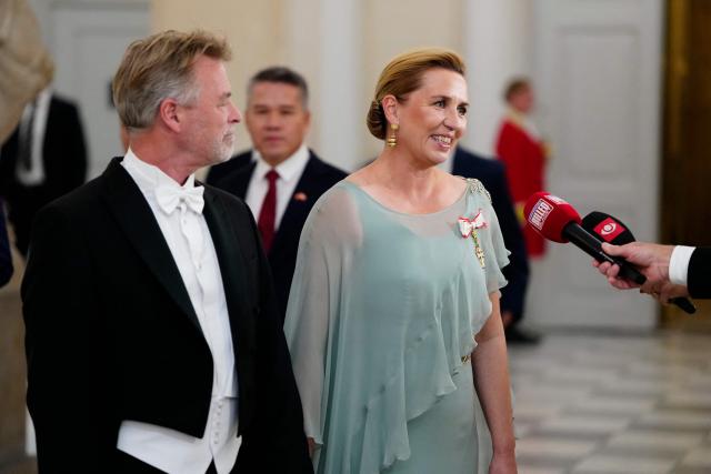 Denmark's Prime Minister Mette Frederiksen, and her husband Bo Tengberg arrive at the gala dinner held for Vietnam's President, To Lam, and his spouse, Ngo Phuong Ly, at Christiansborg Palace in Copenhagen, Denmark, on October 19, 2026. Vietnam's President, To Lam, and his spouse, Ngo Phuong Ly, begin a three-day state visit to Denmark. This year marks the 55th anniversary of the establishment of diplomatic relations between Denmark and Vietnam. (Photo by Mads Claus Rasmussen / Ritzau Scanpix / AFP) / Denmark OUT