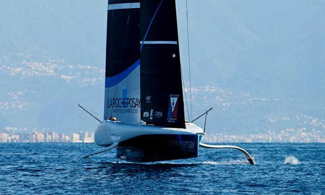 The AC75 boat of the La Roche Posay Team Racing sails off Naples after its launch during a press presentation ahead of the 2027 America's Cup, on October 19, 2026. (Photo by Stefano RELLANDINI / AFP)