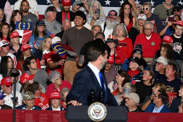 A protester is ejected as US Vice President JD Vance speaks during a campaign rally in Hendersonville, North Carolina, on October 19, 2026. (Photo by Kenny Holston/The New York Times / POOL / AFP)
