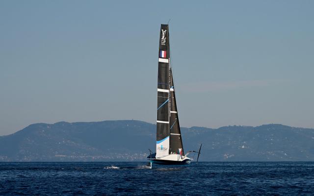 The AC75 boat of the La Roche Posay Team Racing sails off Naples after its launch during a press presentation ahead of the 2027 America's Cup, on October 19, 2026. (Photo by Stefano RELLANDINI / AFP)