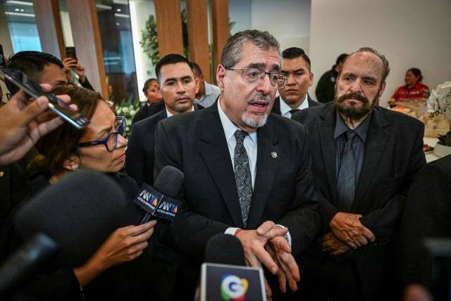 Guatemalan President Bernardo Arevalo speaks with journalists during a memorial ceremony for lawyer Francisco Solorzano Foppa at a funeral home in Guatemala City on October 19, 2026. A former Guatemalan prosecutor who denounced corruption cases and alleged links between gangs and politicians was shot dead in Guatemala City on October 17, 2026, police said. Lawyer Juan Francisco Solorzano Foppa was attacked at a football field he frequented on weekends, according to a police report, which said two suspected perpetrators had been detained on a preliminary basis. (Photo by Johan ORDONEZ / AFP)