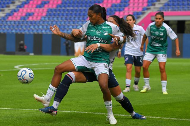 Deportivo Cali's forward #19 Melanin Aponza (front) and Nacional's defender #03 Valentina Cousillas fight for the ball during the 2026 Women's Copa Libertadores Group D football match between Colombia's Deportivo Cali and Uruguay's Nacional at the Banco Guayaquil Stadium in Quito on October 19, 2026. (Photo by Rodrigo BUENDIA / AFP)