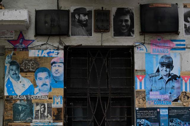 Political posters depicting Venezuelan President Nicolas Maduro, Venezuela's late former president Hugo Chavez, former Cuban president Raul Castro and Cuba's late former leader Fidel Castro are displayed on a building facade in Havana on October 19, 2026. (Photo by YAMIL LAGE / AFP)