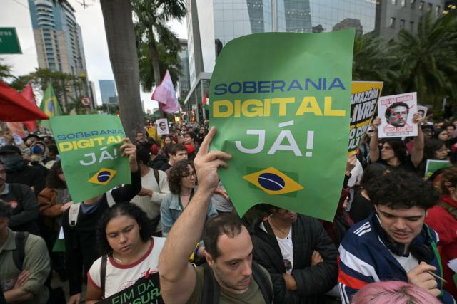 Supporters of Brazil's President and presidential candidate Luiz Inacio Lula da Silva hold signs reading "Digital Sovereignty Now!" during a demonstration in front of Meta's headquarters in Sao Paulo, Brazil, on October 19, 2026, to denounce alleged interference by big tech companies in the Brazilian election. Brazil's electoral court on October 19, 2026 gave Meta 24 hours to show that it is taking measures to ensure equal treatment on its platforms for the campaigns of Luiz Inacio Lula da Silva and Flavio Bolsonaro, less than a week before the presidential runoff election. (Photo by NELSON ALMEIDA / AFP)