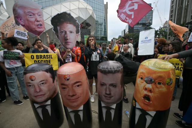Supporters of Brazil's President and presidential candidate Luiz Inacio Lula da Silva take part in a demonstration in front of Meta's headquarters in Sao Paulo, Brazil, on October 19, 2026, holding placards and inflatable figures depicting Meta chief executive Mark Zuckerberg, Tesla and X owner Elon Musk, Telegram founder Pavel Durov and US President Donald Trump, while denouncing alleged interference by big tech companies in the Brazilian election. Brazil's electoral court on October 19, 2026 gave Meta 24 hours to show that it is taking measures to ensure equal treatment on its platforms for the campaigns of Luiz Inacio Lula da Silva and Flavio Bolsonaro, less than a week before the presidential runoff election. (Photo by NELSON ALMEIDA / AFP)