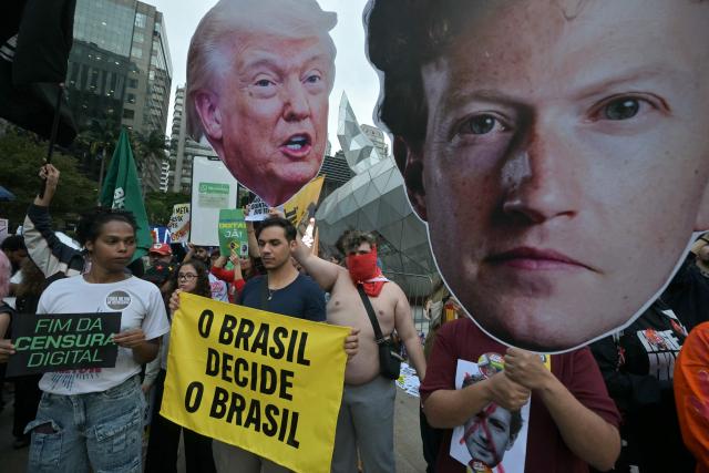 Supporters of Brazil's President and presidential candidate Luiz Inacio Lula da Silva hold signs reading "Brazil Decides Brazil", "End Digital Censorship" and carry oversized cutouts depicting Meta chief executive Mark Zuckerberg and US President Donald Trump during a demonstration in front of Meta's headquarters in Sao Paulo, Brazil, on October 19, 2026, denouncing alleged interference by big tech companies in the Brazilian election. Brazil's electoral court on October 19, 2026 gave Meta 24 hours to show that it is taking measures to ensure equal treatment on its platforms for the campaigns of Luiz Inacio Lula da Silva and Flavio Bolsonaro, less than a week before the presidential runoff election. (Photo by NELSON ALMEIDA / AFP)