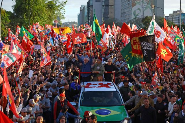 Brazil's President and presidential candidate Luiz Inacio Lula da Silva (L) of the Workers' Party (PT) greets supporters during a rally in Porto Alegre, Rio Grande do Sul state, Brazil, on October 19, 2026, ahead of the presidential runoff election. (Photo by SILVIO AVILA / AFP)