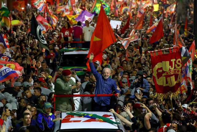 Brazil's President and presidential candidate Luiz Inacio Lula da Silva (C) of the Workers' Party (PT) greets supporters during a campaign rally in Porto Alegre, Rio Grande do Sul state, Brazil, on October 19, 2026, ahead of the presidential runoff election. (Photo by SILVIO AVILA / AFP)