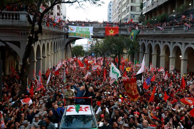 Brazil's President and presidential candidate Luiz Inacio Lula da Silva of the Workers' Party (PT) greets supporters during a campaign rally in Porto Alegre, Rio Grande do Sul state, Brazil, on October 19, 2026, ahead of the presidential runoff election. (Photo by SILVIO AVILA / AFP)