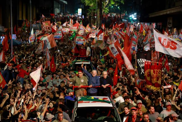 Brazil's President and presidential candidate Luiz Inacio Lula da Silva (C) of the Workers' Party (PT) greets supporters during a campaign rally in Porto Alegre, Rio Grande do Sul state, Brazil, on October 19, 2026, ahead of the presidential runoff election. (Photo by SILVIO AVILA / AFP)