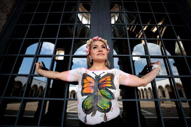A woman affected by breast cancer poses for a photo session during the "A Brushstroke for Life" event in Guadalajara, Jalisco state, Mexico, on October 19, 2026. In the event, 100 women are adorned with body paint by artists. The activity has evolved into an artistic and therapeutic movement aimed at raising public awareness of breast cancer, the most common cancer among women worldwide. It is part of a World Health Organization (WHO) initiative to promote awareness, encourage early detection and highlight the importance of timely treatment. (Photo by ULISES RUIZ / AFP)