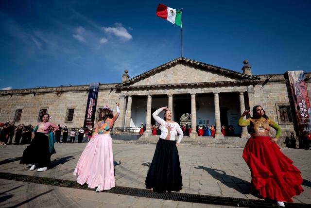 Women affected by breast cancer walk the runway during the "A Brushstroke for Life" event in Guadalajara, Jalisco state, Mexico, on October 19, 2026. In the event, 100 women are adorned with body paint by artists. The activity has evolved into an artistic and therapeutic movement aimed at raising public awareness of breast cancer, the most common cancer among women worldwide. It is part of a World Health Organization (WHO) initiative to promote awareness, encourage early detection and highlight the importance of timely treatment. (Photo by ULISES RUIZ / AFP)
