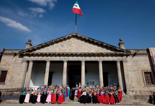 Women affected by breast cancer pose for a photo during the "A Brushstroke for Life" event in Guadalajara, Jalisco state, Mexico, on October 19, 2026. In the event, 100 women are adorned with body paint by artists. The activity has evolved into an artistic and therapeutic movement aimed at raising public awareness of breast cancer, the most common cancer among women worldwide. It is part of a World Health Organization (WHO) initiative to promote awareness, encourage early detection and highlight the importance of timely treatment. (Photo by ULISES RUIZ / AFP)