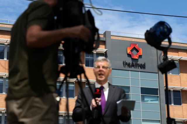 Members of the media work outside Alfred Hospital where Australian politician Helen Haines is being treated in Melbourne on October 20, 2026. Australian independent lawmaker Helen Haines underwent surgery overnight but remains in a critical condition after being struck deliberately by a car in an attack, Prime Minister Anthony Albanese said on October 20. (Photo by Martin KEEP / AFP)