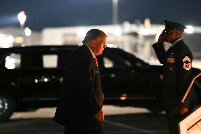 US President Donald Trump walks to board Air Force One at McConnell Air Force Base in Wichita, Kansas, on October 19, 2026. Trump is returning to Washington, DC after speaking at a rally at the Heartlad Credit Union Arena in Wichita, Kansas ahead of the midterm elections. (Photo by Kent NISHIMURA / AFP)