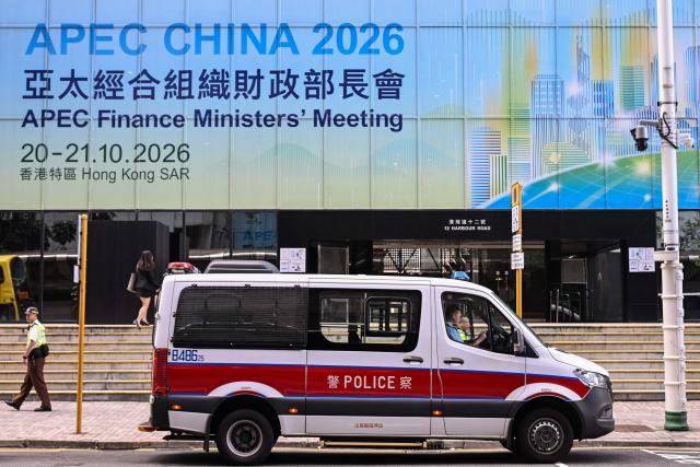 A police van is seen near signage for the Asia-Pacific Economic Cooperation (APEC) Finance Ministers’ Meeting in Hong Kong on October 20, 2026. (Photo by Peter PARKS / AFP)