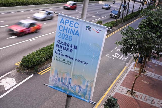 Motorists commute past signage for the Asia-Pacific Economic Cooperation (APEC) Finance Ministers’ Meeting in Hong Kong on October 20, 2026. (Photo by Peter PARKS / AFP)