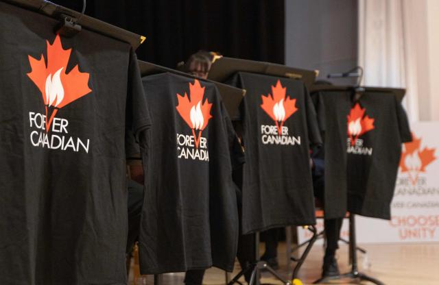 Forever Canadian T-shirts hang on display at a pro-Canada rally at Polish Hall in downtown Edmonton, Alberta, ahead of the referendum results on October 19, 2026. Alberta votes today to determine if it wants to pursue a binding referendum on leaving Canada, with Prime Minister Mark Carney warning a separatist win would bring dangerous uncertainty during a trade war with the United States. Polls indicate less than a quarter of people in the western Canadian province support independence. (Photo by Megan Albu / AFP)
