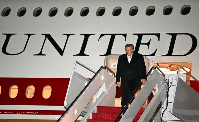 US President Donald Trump disembarks Air Force One at Joint Base Andrews, Maryland on October 19, 2026. President Trump is returning from Wichita, Kansas where he held a campaign rally ahead of the midterm elections. (Photo by Kent NISHIMURA / AFP)