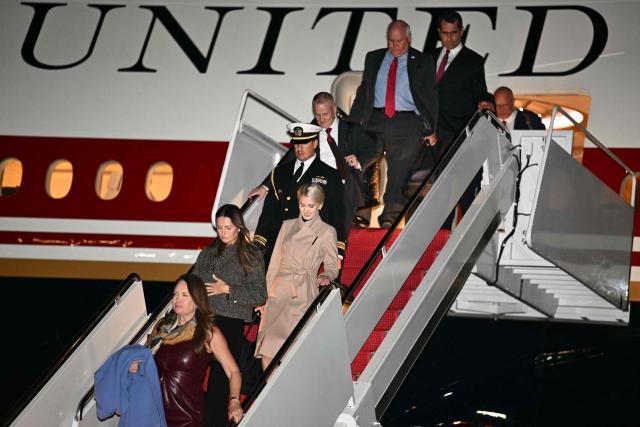 Executive assistant to US President Donald Trump Natalie Harp (3L) and White House Communications Advisor Margo Martin (2L) disembark Air Force One at Joint Base Andrews, Maryland on October 19, 2026. President Trump is returning from Wichita, Kansas where he held a campaign rally ahead of the midterm elections. (Photo by Kent NISHIMURA / AFP)