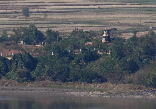 A North Korean guard post and military fences on the North side of the Demilitarised Zone (DMZ) dividing the two Koreas, are seen from a South Korean observatory in the border city of Paju on October 20, 2026. South Korea's military warned October 20, of a "firm" response and resolute punishment for any further provocations by North Korea, saying it was "unacceptable" for Pyongyang to blame Seoul for escalating tensions. (Photo by Jung Yeon-je / AFP)