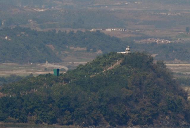 A North Korean guard post (R) and a giant loudspeaker (L) on the North side of the Demilitarised Zone (DMZ) dividing the two Koreas, are seen from a South Korean observatory in the border city of Paju on October 20, 2026. South Korea's military warned October 20, of a "firm" response and resolute punishment for any further provocations by North Korea, saying it was "unacceptable" for Pyongyang to blame Seoul for escalating tensions. (Photo by Jung Yeon-je / AFP)