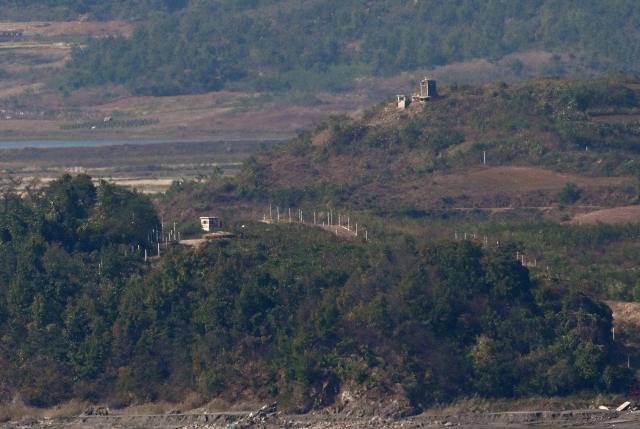 North Korean guard posts and military fences on the North side of the Demilitarised Zone (DMZ) dividing the two Koreas, are seen from a South Korean observatory in the border city of Paju on October 20, 2026. South Korea's military warned October 20, of a "firm" response and resolute punishment for any further provocations by North Korea, saying it was "unacceptable" for Pyongyang to blame Seoul for escalating tensions. (Photo by Jung Yeon-je / AFP)