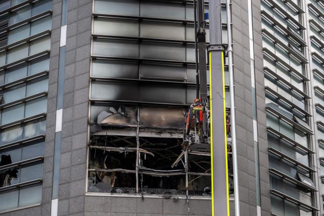 Firefighters works at the scene of a fire at a building in the Gangnam district in Seoul on October 20, 2026. (Photo by Philip FONG / AFP)