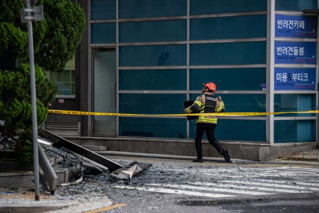 A firefighter works at the scene of a fire at a building in Gangnam district of Seoul on October 20, 2026. (Photo by Philip FONG / AFP)