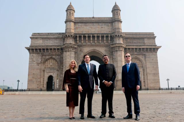 US Secretary of State Marco Rubio (2L) with his wife Jeanette Dousdebes Rubio (L) poses for a photo with Maharashtra Chief Minister Devendra Fadnavis (2R) and US Ambassador to India Sergio Gor at the Gateway of India in Mumbai on October 20, 2026. (Photo by Kylie Cooper / POOL / AFP)
