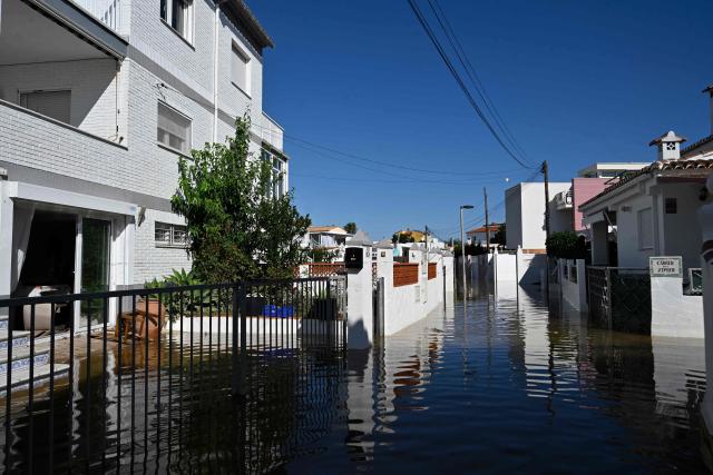 A picture taken on October 20, 2026 shows a flooded street following torrential downpours by the beach in Oliva, in the Valencia region, eastern Spain. Torrential rain battered eastern Spain, unleashing severe flooding that left at least four people dead in recent days, inundated streets and forced many residents to stay indoors. (Photo by Jose JORDAN / AFP)