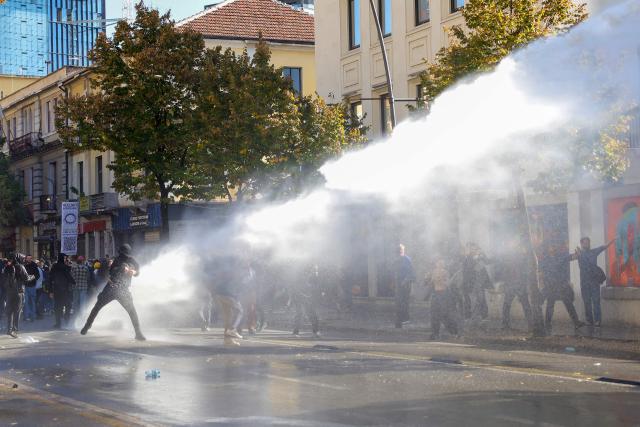 Riot police officers use water canons against protesters during an anti-government demonstration in central Tirana on October 20, 2026, after a week of violent anti-government demonstrations. Albanian Prime Minister Edi Rama on October 20, 2026 blamed a "hybrid war" for fuelling unrest in his country, after a week of violent anti-government demonstrations in Tirana.
Demonstrators have repeatedly clashed with police since Tuesday as months of protests escalate, driven by fresh demands for better university conditions, anger over corruption and renewed calls for Rama's resignation. (Photo by Adnan Beci / AFP)