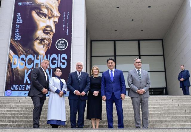 The director of the Museum of Prehistory and Early History at the National Museums in Berlin (SPK) Matthias Wemhoff (L), German President Frank-Walter Steinmeier (3rdL), his wife Elke Buedenbender (3rdR), Mongolia's President Ukhnaagiin Khurelsukh (2ndR) and Director General of the Berlin State Library (SPK) Professor Dr. Achim Bonte (R) pose on the stairs at the entrance of the James-Simon-Galerie museum  before visiting the exhibition „Dschingis Khan und die Welt der Mongolen“ (“Genghis Khan and the World of the Mongols”) on October 20, 2026 in Berlin. Mongolia's President is on a three-day State visit in Germany. The exhibition has been organized to mark the 800th anniversary of the death of Genghis Khan, the founder of the Mongolian empire in 2027. (Photo by John MACDOUGALL / AFP)