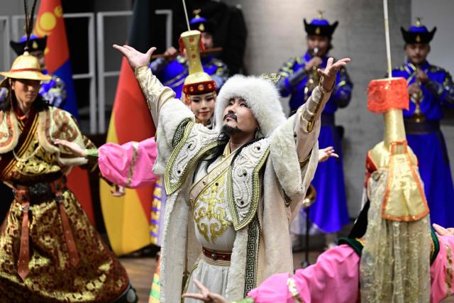 Performers wearing traditional Mongolian outfits dance during the opening ceremony for the exhibition „Dschingis Khan und die Welt der Mongolen“ (“Genghis Khan and the World of the Mongols”), also attended by the German and the Mongolian President (both unseen) at the James-Simon-Galerie museum in Berlin on October 20, 2026. Mongolia's President is on a three-day State visit in Germany. The exhibition has been organized to mark the 800th anniversary of the death of Genghis Khan, the founder of the Mongolian empire in 2027. (Photo by John MACDOUGALL / AFP)