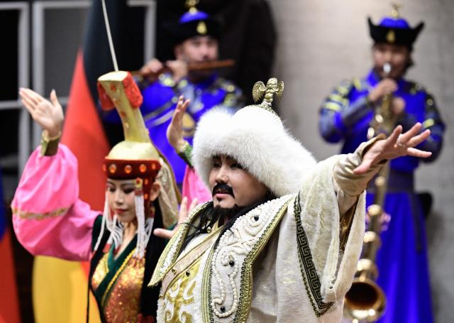 Performers wearing traditional Mongolian outfits dance during the opening ceremony for the exhibition „Dschingis Khan und die Welt der Mongolen“ (“Genghis Khan and the World of the Mongols”), also attended by the German and the Mongolian President (both unseen) at the James-Simon-Galerie museum in Berlin on October 20, 2026. Mongolia's President is on a three-day State visit in Germany. The exhibition has been organized to mark the 800th anniversary of the death of Genghis Khan, the founder of the Mongolian empire in 2027. (Photo by John MACDOUGALL / AFP)
