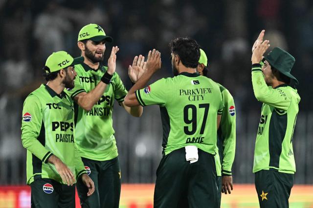 Pakistan's captain Shaheen Shah Afridi (2L) celebrates with teammates after the dismissal of England's Sam Curran during the one-day international (ODI) tri-series cricket match between Pakistan and England at the Rawalpindi Cricket Stadium in Rawalpindi on October 20, 2026. (Photo by Aamir QURESHI / AFP)