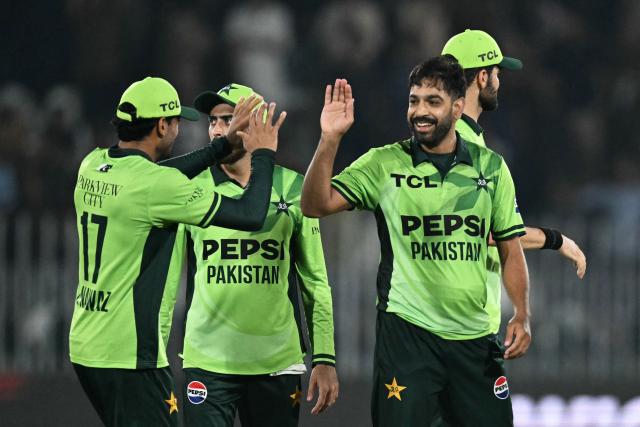 Pakistan's Haris Rauf (2R) celebrates with teammates after taking the wicket of England's Sam Curran during the one-day international (ODI) tri-series cricket match between Pakistan and England at the Rawalpindi Cricket Stadium in Rawalpindi on October 20, 2026. (Photo by Aamir QURESHI / AFP)