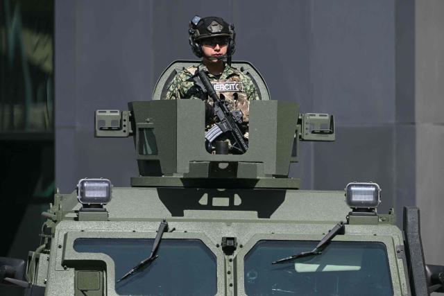 A Mexican Army soldier stands guard on a military vehicle during the signing of the Interinstitutional Coordination Agreement between the Secretariat of National Defense and the Secretariat of Security and Citizen Protection in Mexico City on October 20, 2026. (Photo by Yuri CORTEZ / AFP)
