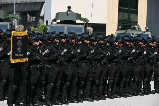 Members of a Mexican special forces unit stand in formation during the signed Interinstitutional Coordination Agreement between the Secretariat of National Defense and the Secretariat of Security and Citizen Protection in Mexico City on October 20, 2026. (Photo by Yuri CORTEZ / AFP)