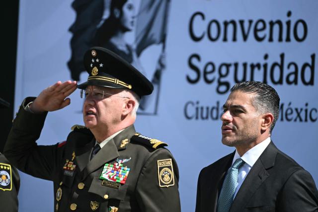 Mexico's Secretary of National Defense General Ricardo Trevilla Trejo (L) and Mexico's Secretary of Security and Citizen Protection Omar Garcia Harfuch attend the signed Interinstitutional Coordination Agreement between the Secretariat of National Defense and the Secretariat of Security and Citizen Protection in Mexico City on October 20, 2026. (Photo by Yuri CORTEZ / AFP)