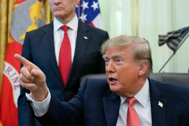 US President Donald Trump and US Vice President JD Vance (not picture) make an announcement on fraud in the Oval Office of the White House in Washington, DC, on October 20, 2026. (Photo by Jim WATSON / AFP)