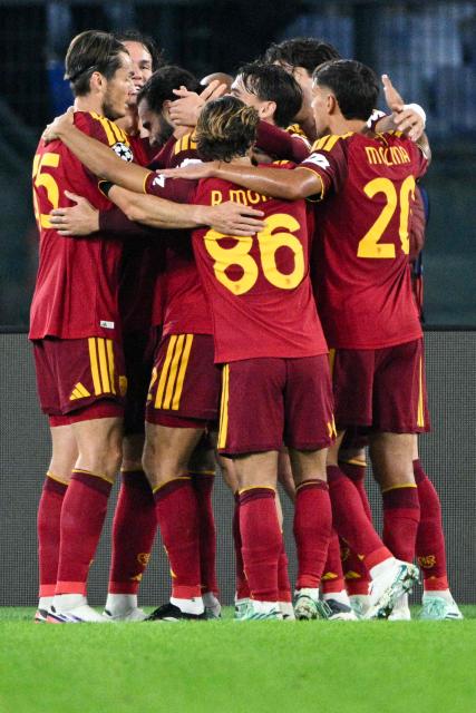 AS Roma's Spanish defender #22 Mario Hermoso (2nd L) celebrates after scoring a goal with his teammate during the UEFA Champions League - 1st round day 3 football match between AS Roma and Slovan Bratislava at the Olympic Stadium in Rome on October 20, 2026. (Photo by Andreas SOLARO / AFP)